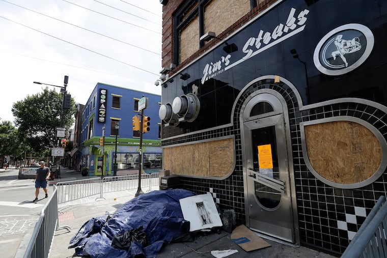 A boarded-up Jim's Steaks along 4th and South Streets on Sunday, July 31, 2022.