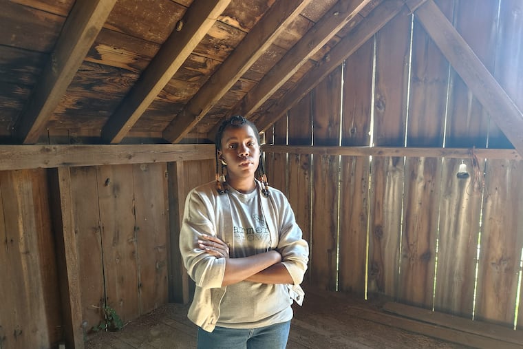 Christa Barfield, the founder of Farmer Jawn, poses in the Westtown Township barn where her team discovered hateful graffiti this month.