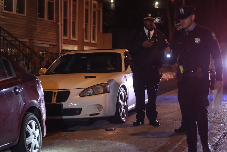 A teen male attempted to carjack a white Pontiac from a 60-year-old man and the two exchanged gunfire at Sharpnack and Cherokee Streetsi in West Mount Airy. The 60-year-old had a permit to carry. The man's gun can be seen on the hood of the car and the carjacker's gun is on the ground in front of the car. Thursday, Jan. 13, 2022.