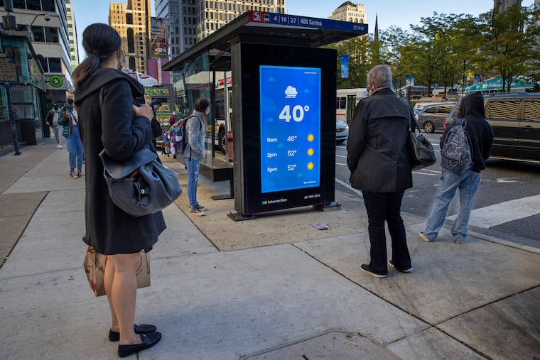 Commuters waiting for the bus at 15th Street above Market on Wednesday morning. It was chilly in Philly, but it got all the way down to 27 in Pottstown.