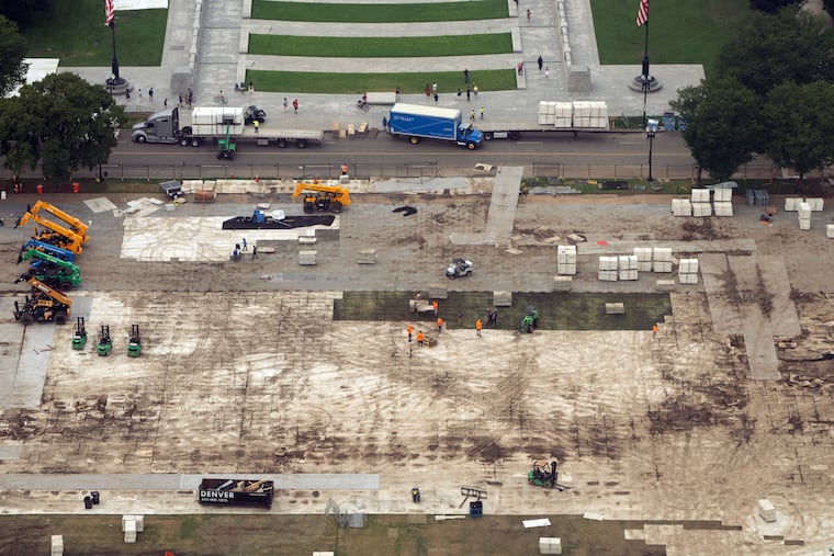 Workers dismantle structures from Salute to America, an Independence Day event honoring the nation's 250th anniversary, as seen from the Washington Monument, on July 10, 2026, in Washington.