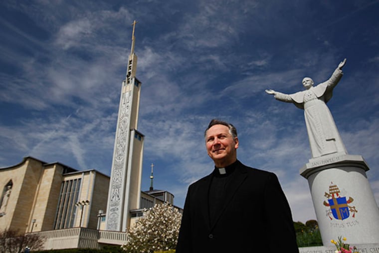 Monsignor George Majoros of St. Jude Parish will deliver rhe homily at a Mass honoring John Paul II at the National Shrine of Our Lady of Czestochowa. The shrine is at left and a statue of John Paul II is at right. (MICHAEL S. WIRTZ / Staff Photographer)