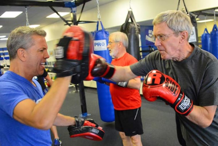Rich Mushinsky left, owner of Fit 4 Boxing Club, practices with Dick Herchenroether, 64, on July 2, 2015 in Allison Park, Pa. The inaugural class of Rock Steady boxing is a non-contact boxing program for people with Parkinson's disease.
