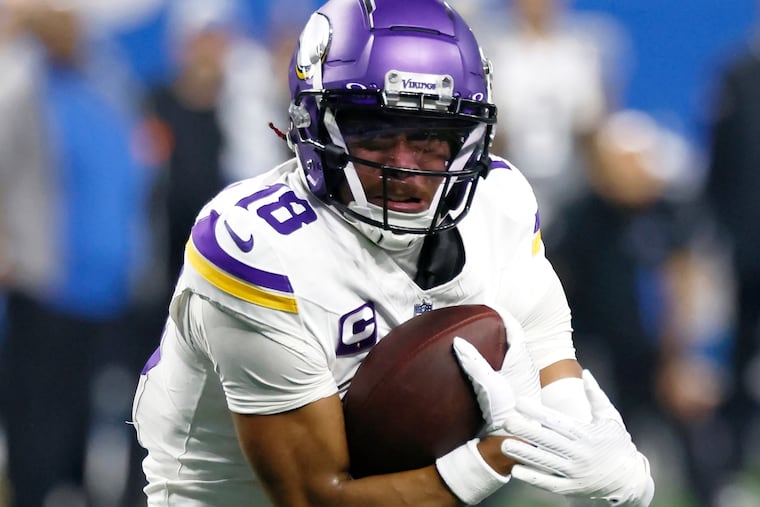 Minnesota Vikings wide receiver Justin Jefferson carries the ball against the Detroit Lions on Jan. 7.
