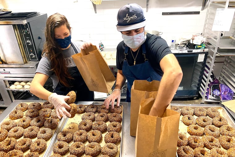 Alexandra and Jacob Cohen of Kismet Bagels wrangling their product into bags.