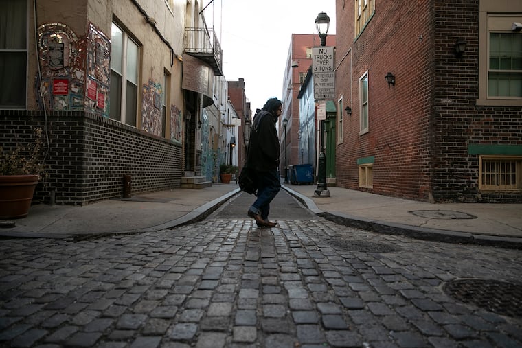 A pedestrian walks down the 200 block of Camac in Center City.