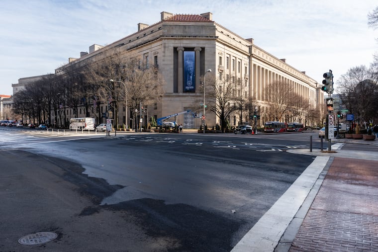 A banner of President Donald Trump hangs on the Department of Justice headquarters in Washington, Feb. 20, 2026. Judges and grand juries have increasingly lost faith in the Justice Department as the president uses it to reward his friends and go after his opponents.