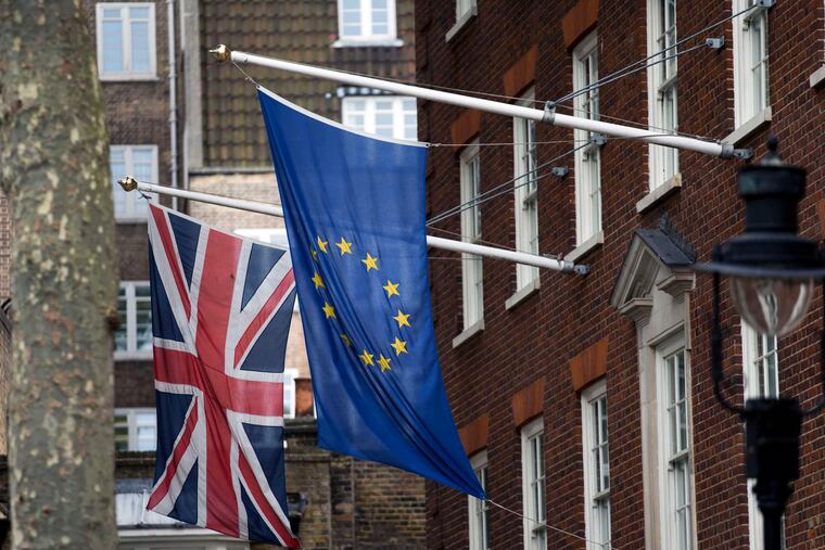 The flags of Britain and the European Union outside Europe House, the European Parliament's offices in London.British voters chose to leave the EU in a referendum on Thursday. MATT DUNHAM / AP