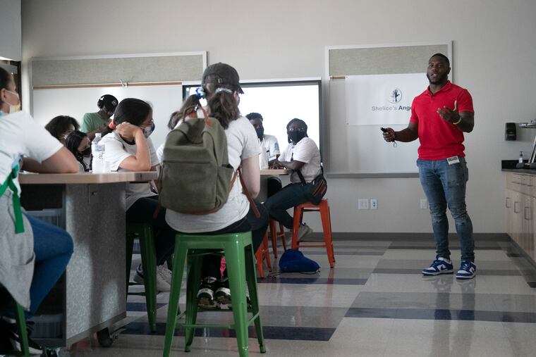 NFL linebacker Zaire Franklin of the Indianapolis Colts speaking to students on the first day of his business academy at Russell H. Conwell Middle Magnet School in the Kensington section of Philadelphia on Wednesday.