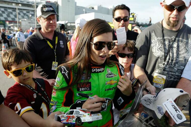Danica Patrick signs autographs for fans after her qualifying run for
Saturdays NASCAR Nationwide Series auto race, Friday, Feb. 22, 2013,
at Daytona International Speedway in Daytona Beach, Fla. (Chris O'Meara/AP)