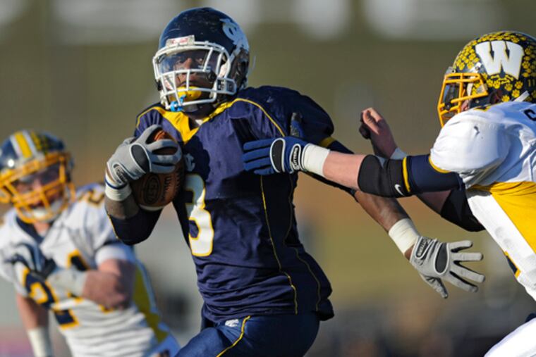 Raymond Maples of West Catholic runs away from the grasp of Wilmington safety Shane Wagner in the third quarter.