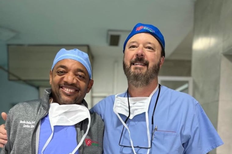 Mesfin Yana Dollar, left, with cardiothoracic surgeon Jim Kauten, who operated on him many years ago. The two men now perform surgeries together on mission trips to Ethiopia. MUST CREDIT: Allen Dollar