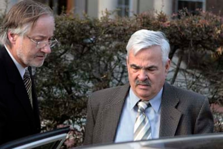 Thomas McFarland (right), the Main Line dentist who dumped medical waste off the Jersey Shore, leaves the Cape May County Courthouse after his arraignment on January 15. (Elizabeth Robertson / Staff Photographer)