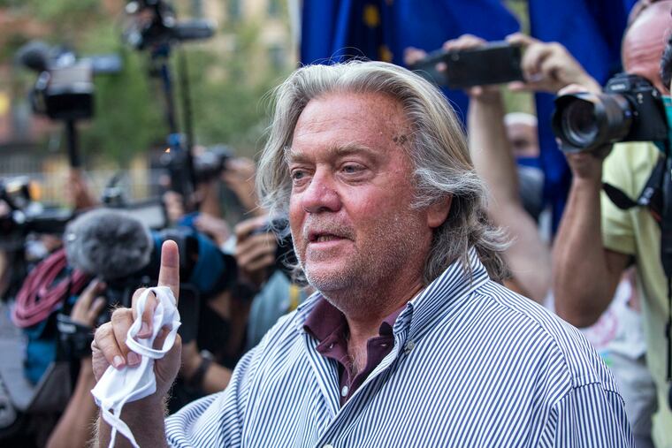 President Donald Trump's former chief strategist, Steve Bannon, speaks with reporters in August after pleading not guilty to charges that he ripped off donors to an online fundraising scheme to build a southern border wall.
