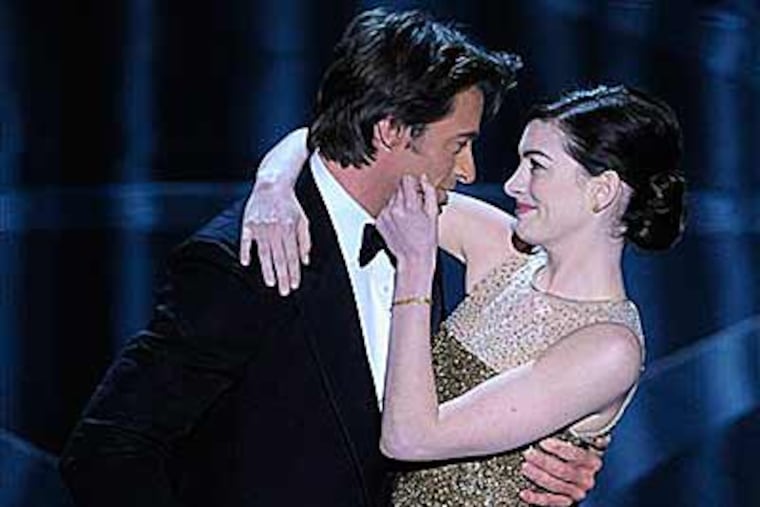 Oscar host Hugh Jackman performs a skit with actress Anne Hathaway during the 81st Academy Awards Sunday. (AP Photo/Mark J. Terrill)