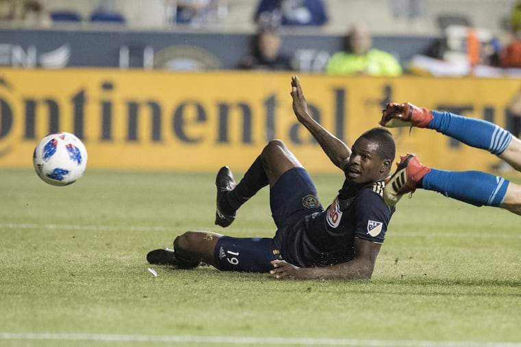 Cory Burke, left, of the Union tries to score against Patrick McLain of the Fire in the 2nd half. The shot did not go in. The Union won 3-1 over the Chicago Fire on May 30, 2018.