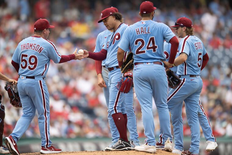 Phillies pitcher Taijuan Walker hands the ball to manager Rob Thomson for a pitching change during a game in July.
