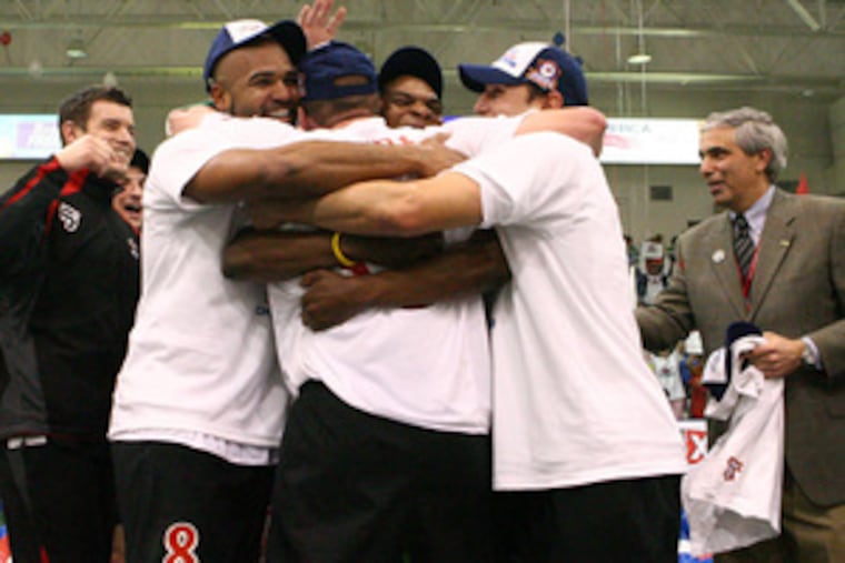 Members of the Kixx (from left) John Barry Nusum, Pat Morris (whose back is to the camera), Ptah Myers and Andy Gaustaferro celebrate taking the MISL championship with a 13-8 victory over Detroit.