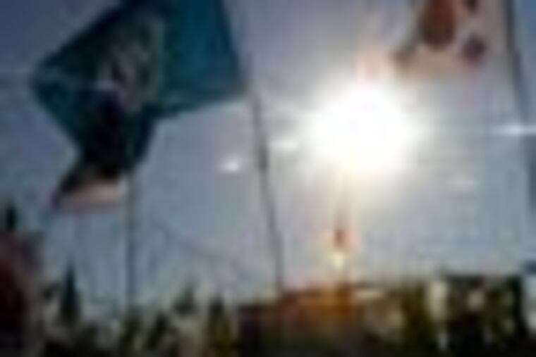 Flags of United Nations, left, and South Korea flutter over the barbed-wire fence with the banners wishing for reunification of the two Koreas at the Imjingak Pavilion near the border village of the Panmunjom (DMZ) that separates the two Koreas since the Korean War, in Paju, north of Seoul, South Korea, Monday, Dec. 26, 2011. North Korea's state media on Monday called Kim Jong Il's heir the head of the ruling Workers' Party Central Committee, a job that gives Kim Jong Un power over one of the country's highest decision-making bodies more than a week after his father's death. (AP Photo/ Lee Jin-man)