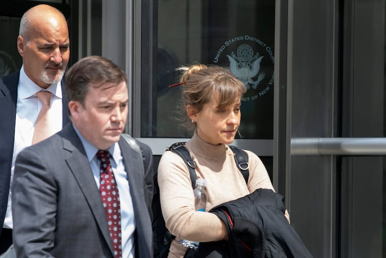Actress Allison Mack leaves Brooklyn federal court Monday, April 8, 2019, in New York. Mack pleaded guilty to racketeering charges on Monday in a case involving a cult-like group based in upstate New York. The trial is expected to detail sensational allegations that the group, called NXIVM, recruited sex slaves for its spiritual leader, Keith Raniere.(AP Photo/Mark Lennihan)