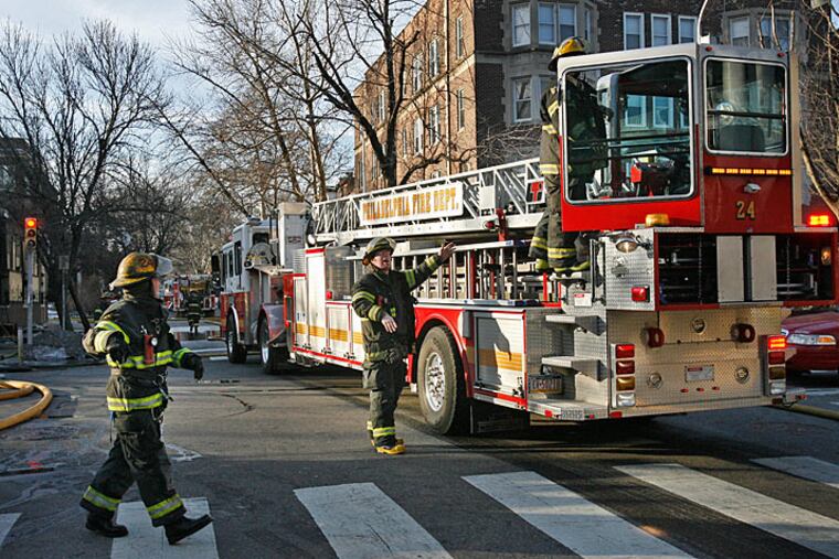 Philadelphia fire fighters extinguish a fire at Transition to Independent Living Inc, at the corner of 46th and Spruce streets, on Wednesday morning