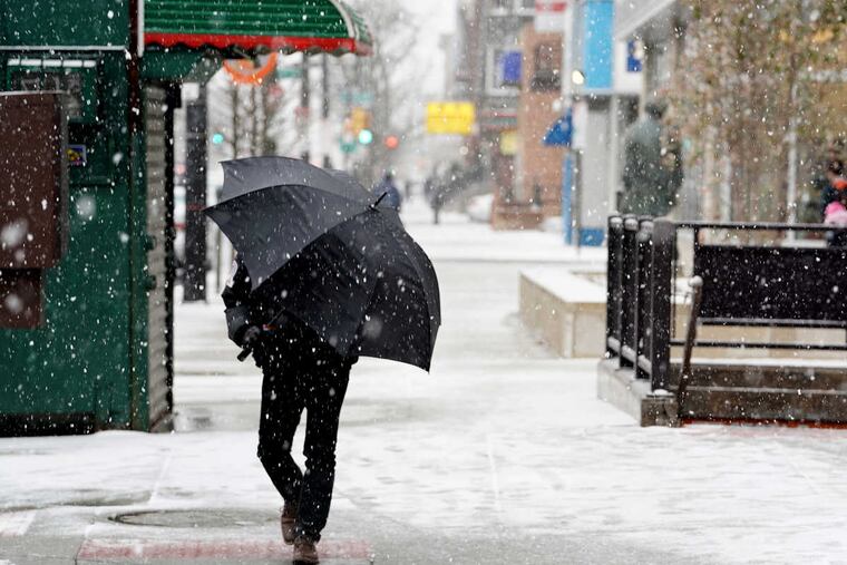 Snow falls at the corner of Broad and Morris streets in South Philadelphia, Tuesday, March 20th, 2018.