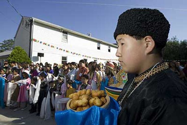 Stephan Burushkin, of Voorhees, holds a basket of Bortsix to present to the Dalai Lama. He is with other Kalmyk and Tibetan children waiting to greet His Holiness.