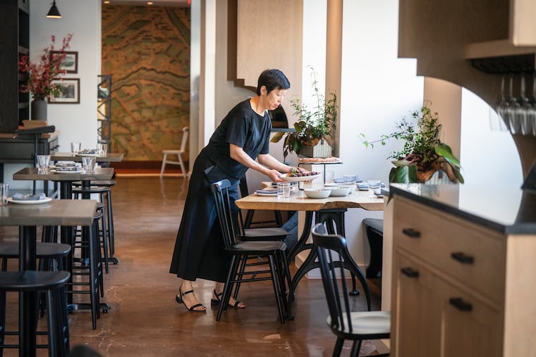 Restaurateur Ellen Yin setting a table before the opening of High Street, at Ninth and Chestnut Streets.