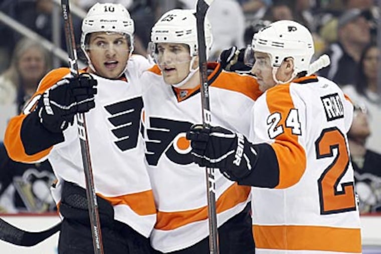 Matt Carle (center) scored the first goal of Friday's game on a power play in the first period. (Yong Kim/Staff Photographer)