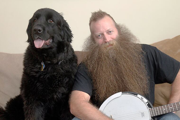 Jeff Langum, 39, the winner of the World Beard Championship, and his pet Newfoundland dog "Abby" at his Voohees, NJ home on Jan. 28, 2014. ( AKIRA SUWA / Staff Photographer )