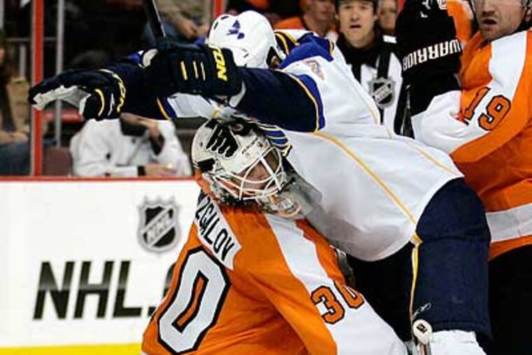 The Blues' Jason Arnott collides with Ilya Bryzgalov in the first period. (Tom Mihalek/AP)