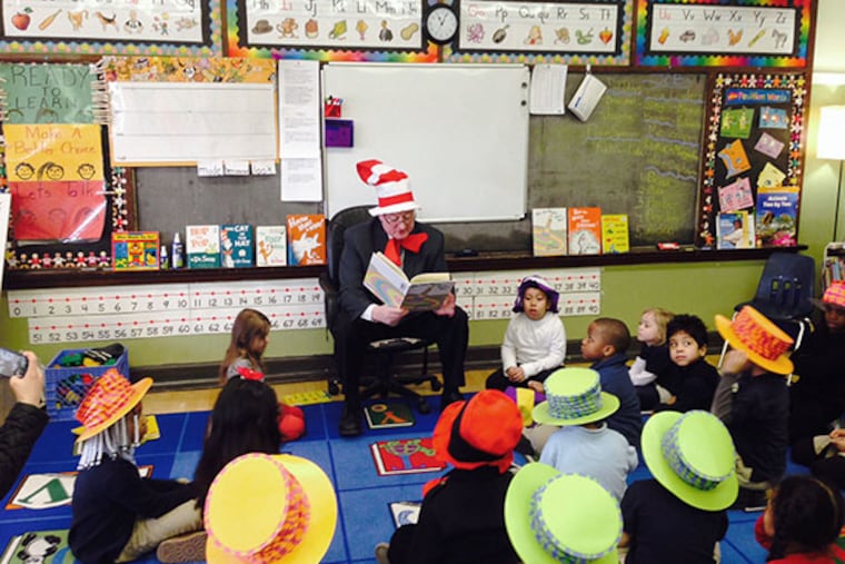 In a silly hat , Jim Kenney reads to kindergartners at Andrew Jackson School in S. Phila. to mark the birthday of Dr. Seuss. (Chris Brennan/Staff)