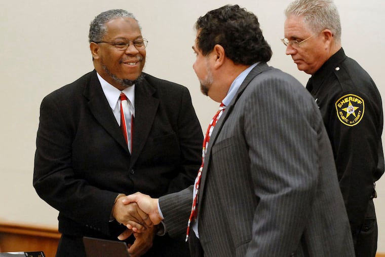 Craig Callaway, left, shakes hands with his attorney Joseph Grassi after being sentenced in Superior Court in Mays Landing, N.J., in 2008.