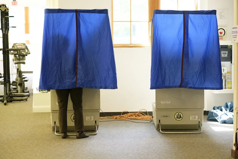 A voter casts her ballot.