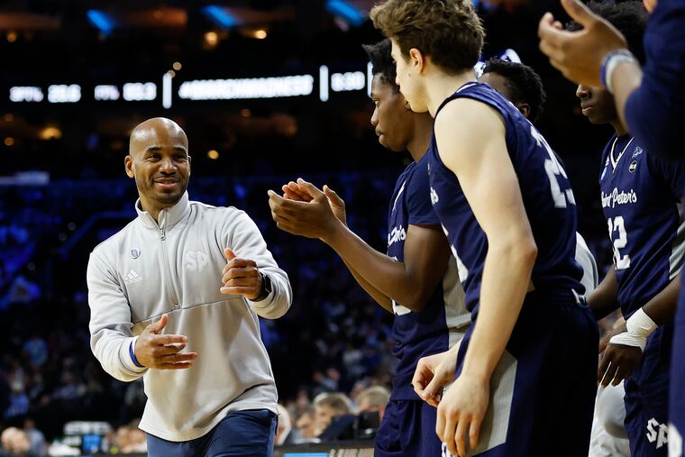 St. Peter's Head Coach Shaheen Holloway smile with his team in the second half against Purdue during a East Regional Sweet 16 game on Friday, March 25, 2022.