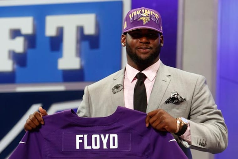 Sharrif Floyd holds up a team jersey after being selected 23rd overall by the Minnesota Vikings in the first round of the NFL football draft, Thursday, April 25, 2013, at Radio City Music Hall in New York. (Jason DeCrow/AP)