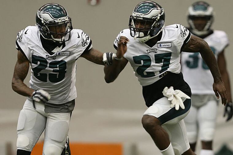 Eagles cornerback Nolan Carroll (left) and Malcolm Jenkins work together during practice.