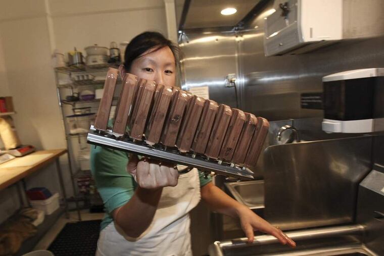 Lil' Pop Shop owner Jeanne Chang with chocolate with salted caramel brownie. ( STEVEN M. FALK / Staff Photographer )