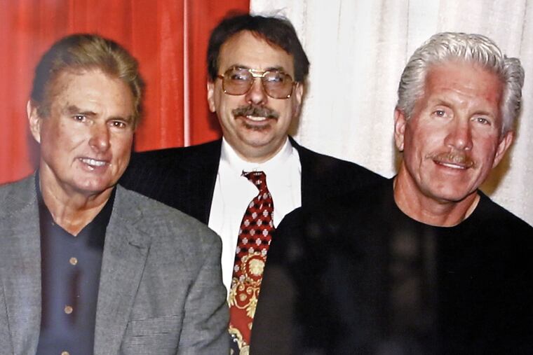DePace Sports Museum co-owner Nick DePace (center) with Phillies greats Steve Carlton (left) and Mike Schmidt in an undated photo, which hangs in the DePace Sports Museum in Collingswood.