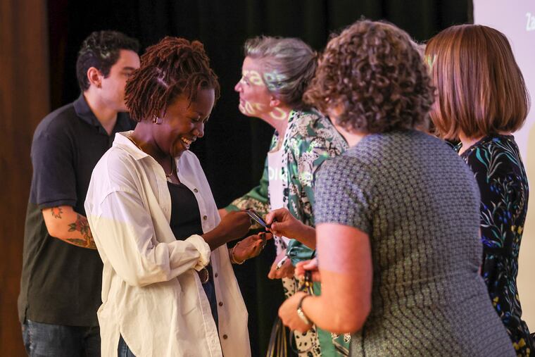 Faculty of Drexel’s Dornsife School of Public Health hand new students pins to celebrate their enrollment in the school on Friday.