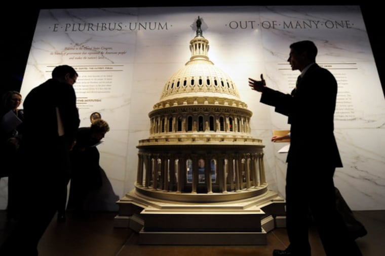 A cross-section of the Capitol Dome serves as the backdrop for Capitol Visitor Center spokesman Tom Fontana (right).He was giving a tour of the new Capitol Visitor Center, where visits begin in the vast, statue-filled Emancipation Hall.