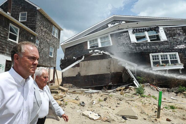 File: DEP Commissioner Bob Martin (foreground) and Toms River Mayor Tom Kelaher walk by a home in August 2013 in Toms River that was ravaged by Sandy. Martin told a N.J. Assembly committee on Monday that no long-term funding source for land and historic preservation has been established.