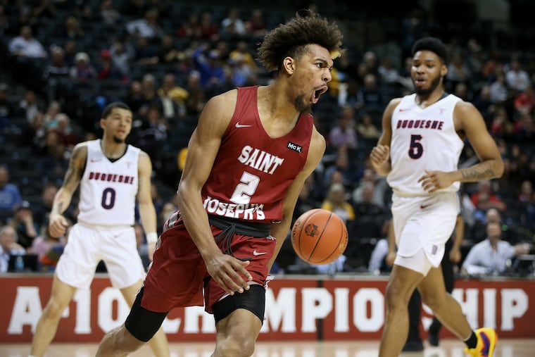 St. Joseph's Charlie Brown Jr. (2) celebrates after dunking the ball during his team's second-round Atlantic 10 Tournament game against Duquesne at the Barclays Center in Brooklyn, N.Y., on Thursday, March 14, 2019. St. Joseph's won 92-86.