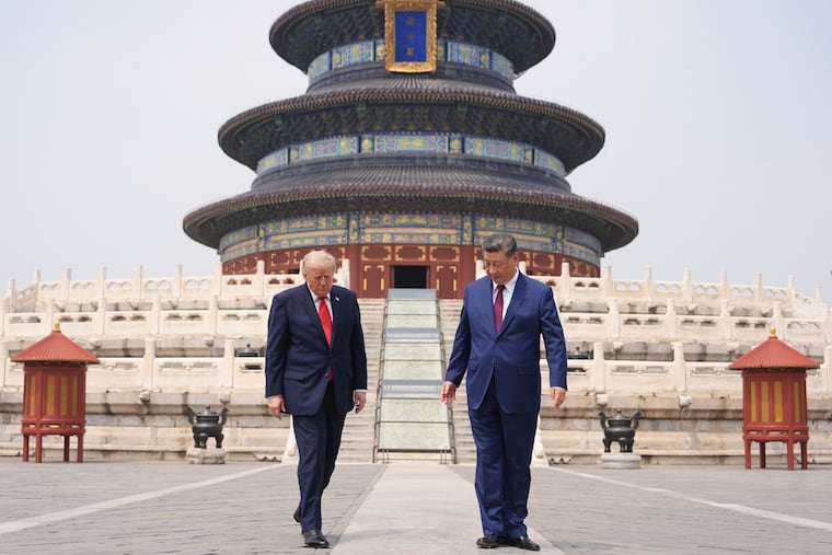 President Donald Trump, left, walks with Chinese President Xi Jinping at the Temple of Heaven on Thursday May 14, 2026, in Beijing.