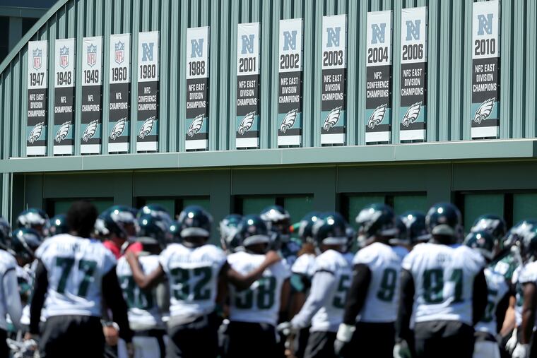 Eagles' players gather with their past championship banners behind them during the last day of the Eagles three-day mandatory minicamp in Philadelphia, PA on June 13, 2018. DAVID MAIALETTI / Staff Photographer
