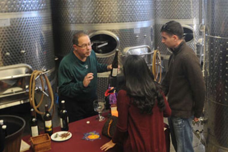 Sharrott Winery's Harris Friedberg (left) offers a sample to Aimee Worrall and Derek Washburn.