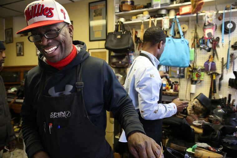 Jerry Burrell (left) laughs as he and Terrence Banks repair shoes at Cliff's Shoe Shine on S. 40th Street in Philadelphia. It has been a family run business for three generations.