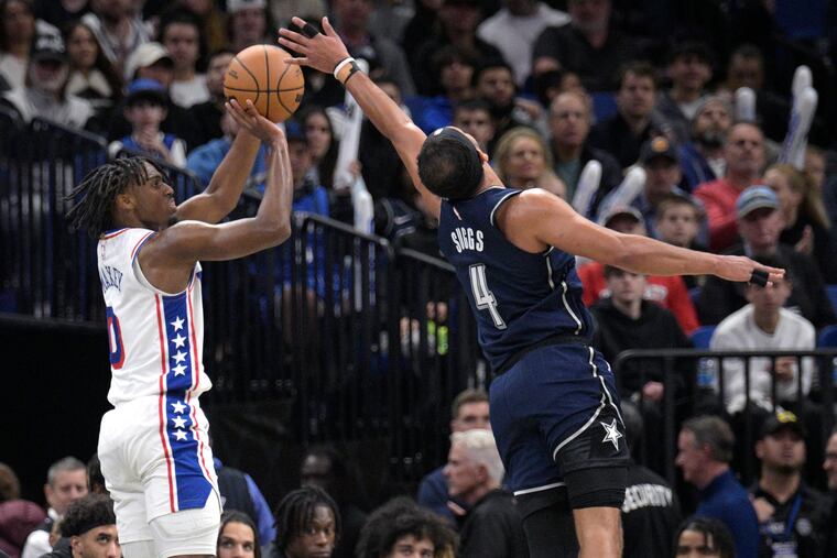 Tyrese Maxey shoots a three-pointer as Orlando Magic guard Jalen Suggs defends during the second half on Dec. 27.