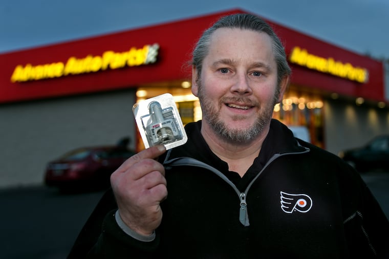 Bill Kinkle poses with naloxone outside the auto parts store where he works in Glenside