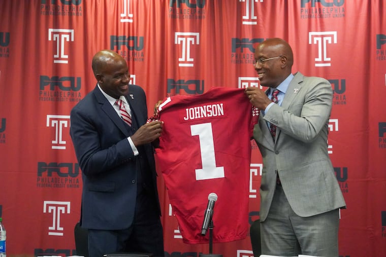 Arthur Johnson, left, the new Athletic Director and Vice President of Temple and president Jason Wingard hold up a jersey during a news conference on Thursday.